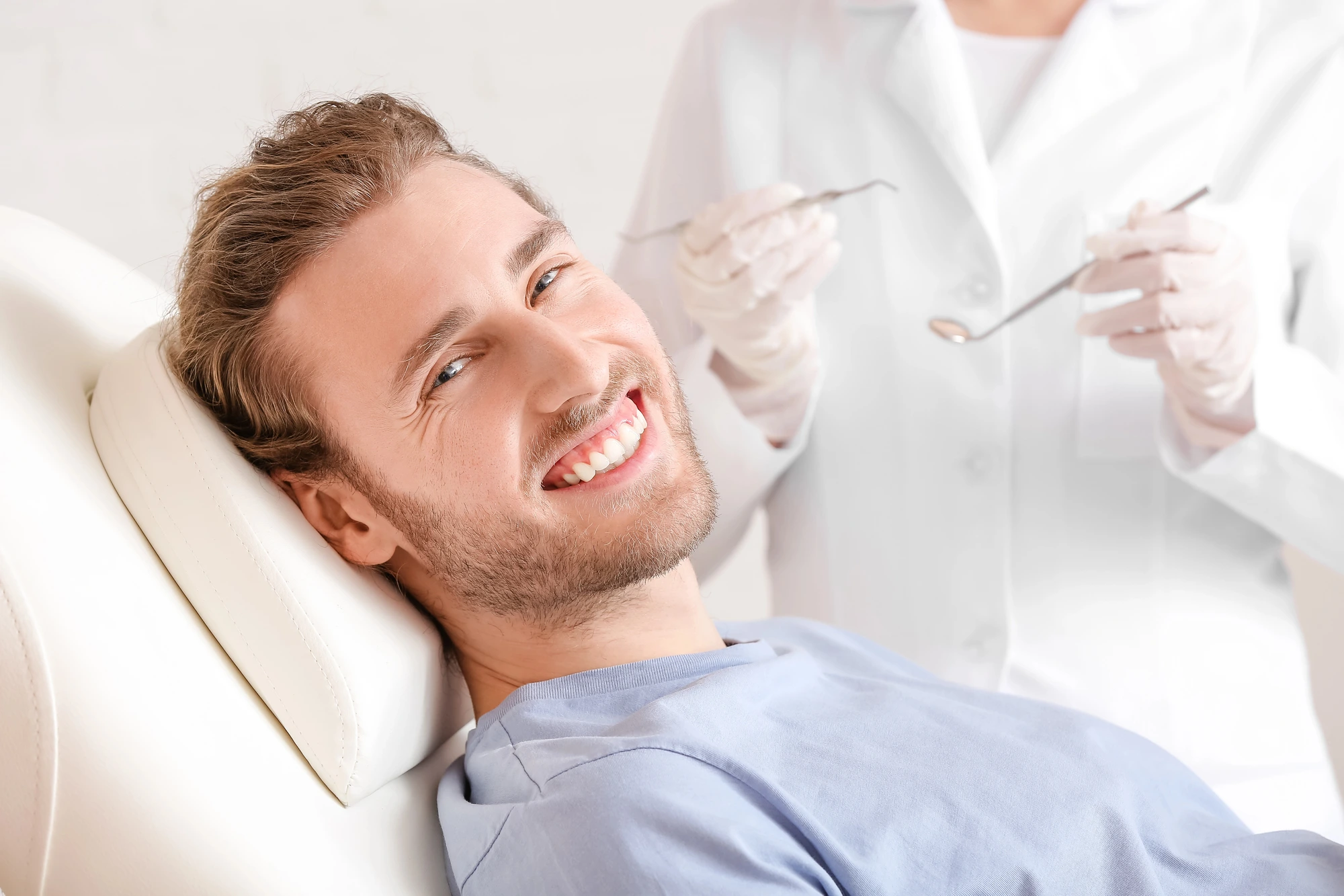 man lying on dentist chair while getting veneers in Cary.
