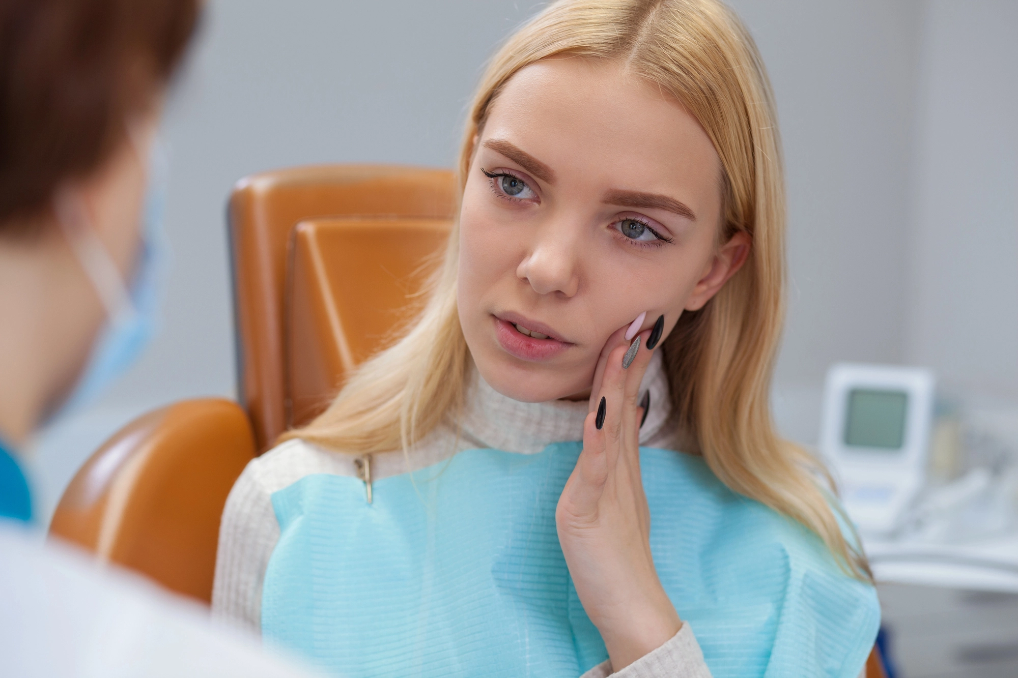 patient telling emergency dentist in Cary about dental pain