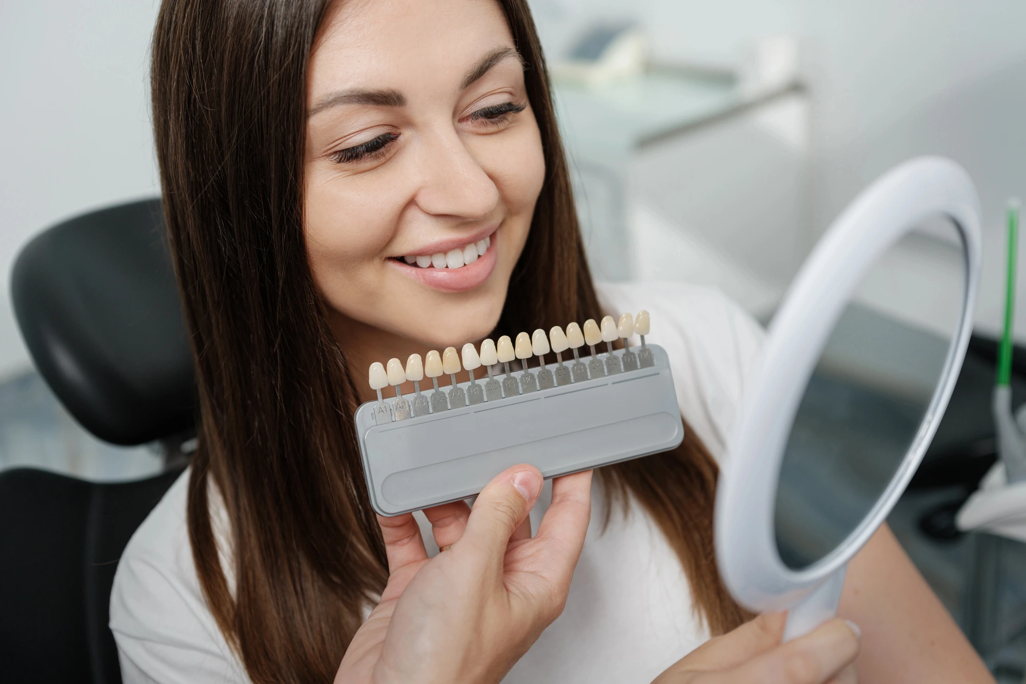 woman comparing different teeth options while discussing Invisalign in Cary, NC