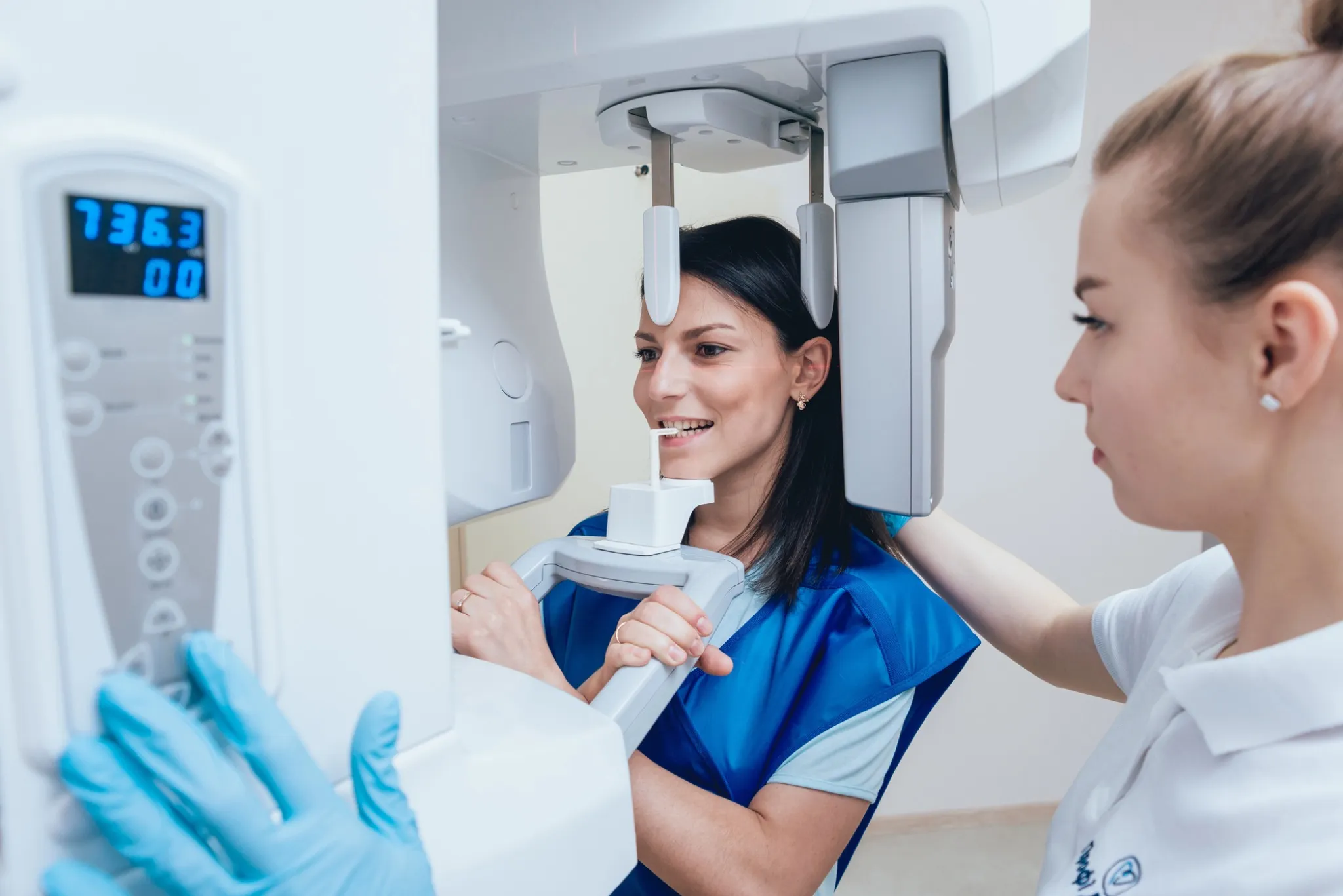 woman receiving an x-ray at a general dentist in Cary