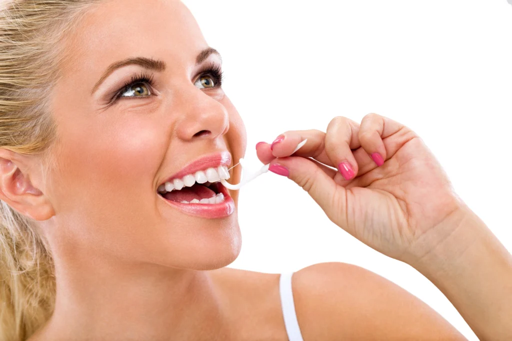 happy-woman-flossing-after-going-to-the-dentist-in-Cary-NC